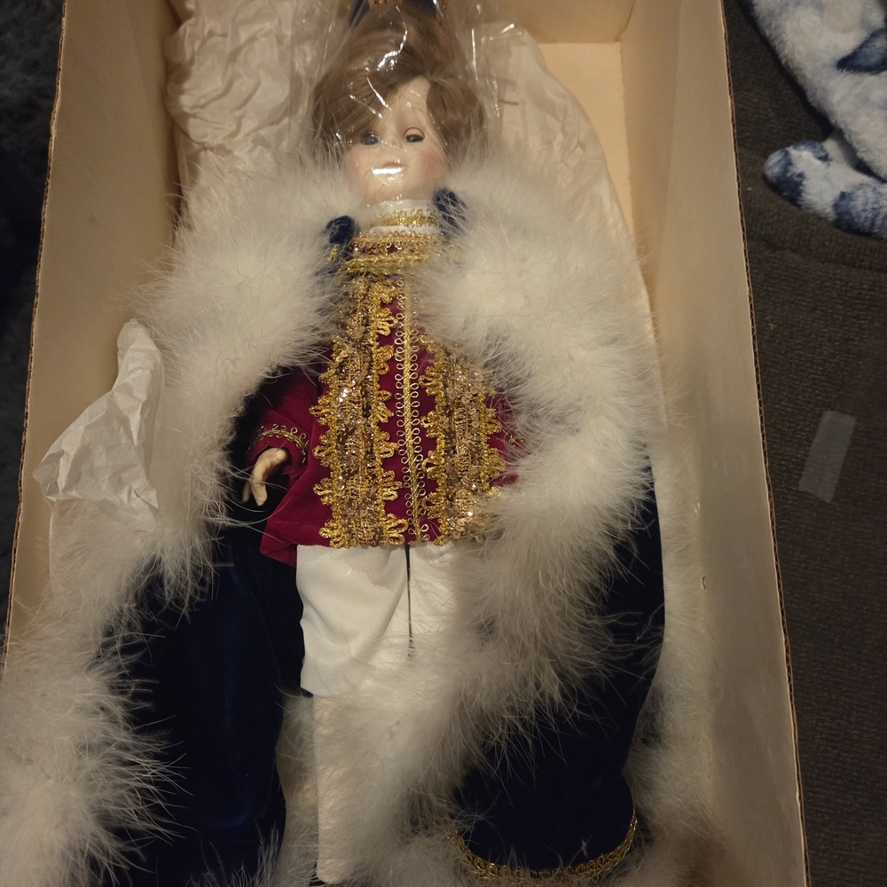 Elegant Porcelain Doll with Gold and Red Accents